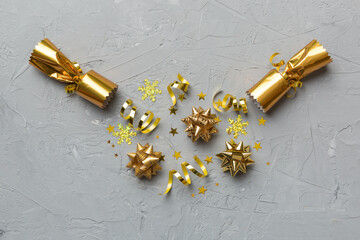 Christmas crackers with shiny confetti on color background, top view, copy space
