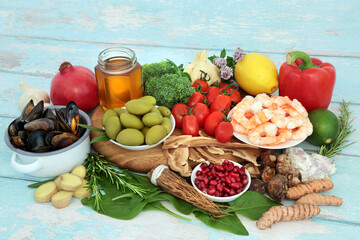 Healthy food to boost the immune system with seafood, vegetables, fruit, honey, herbs and spice. Health foods very high in antioxidants, anthocyanins, protein, fibre, vitamins, minerals and omega 3.  