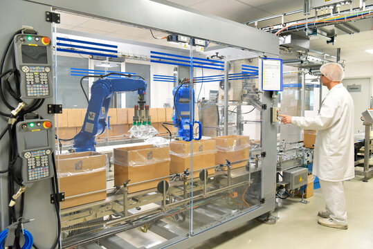 medical products manufacturing in a modern factory - worker operates modern industrial plant