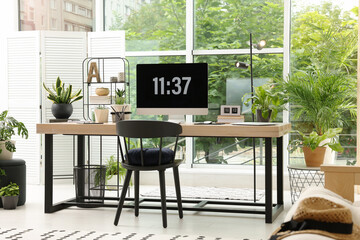 Comfortable workplace with computer in light room. Interior design