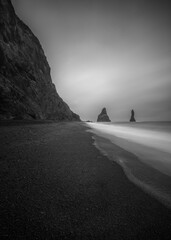 Black sand beach Troll fingers in black and white photo
