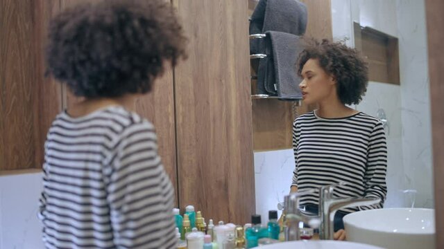 Nervous woman talking to mirror reflection, preparing for important conversation