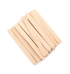 Disposable wooden spatulas for depilatory wax on white background, top view
