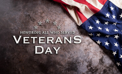 Fototapeta na wymiar Happy Veterans Day concept. American flags against a dark stone background. November 11.