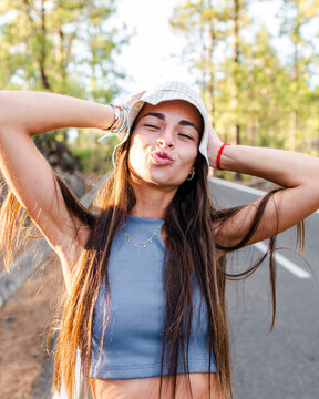 Smiling teen with pouting lips on road