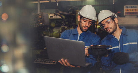 Team of industrial machinery engineers check the wear and tear of the machine gears to replace the...