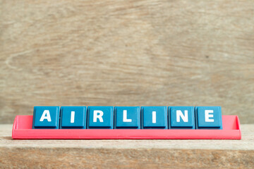 Tile alphabet letter with word airline in red color rack on wood background