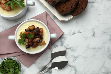 Potato puree and tasty fried cracklings served on white marble table, flat lay with space for text. Cooked pork lard