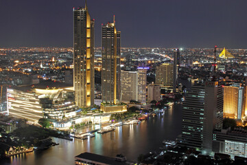The Cityscape, the Skyscraper and the Chao Phraya River of Bangkok Thailand in the Night