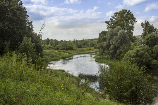 Serene landscape of Protva river flowing through a green forest in Russia