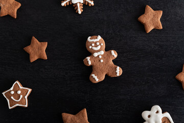 Gingerbread man and stars close up on black background