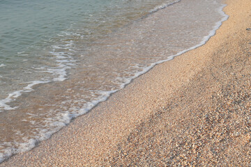 Beautiful seascape with beautiful sea waves and sea foam on shore with sea water on beach by sea