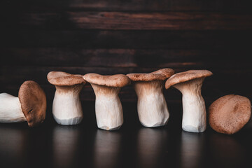 Raw king trumpet mushroom on wooden table