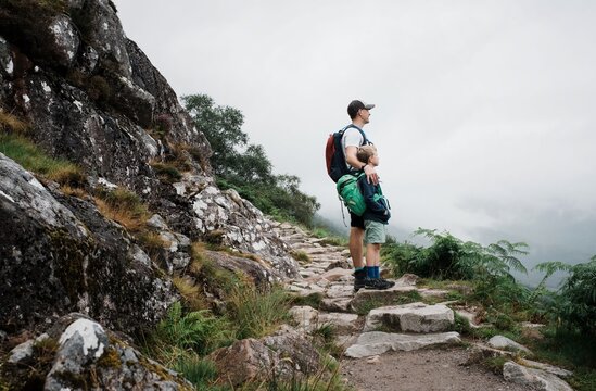 father and son climbing Ben Nevis mountain range in the UK