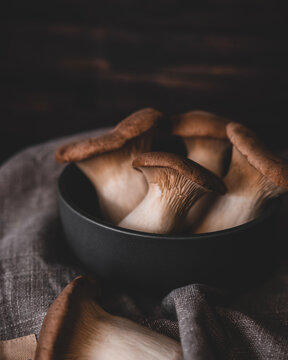 dark grey bowl full of king trumpet mushrooms