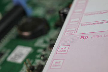 Viersen, Germany - May 9. 2021: View on german medical prescription slip on computer circuit board