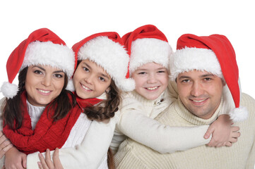 Portrait of family with kids in santa hats
