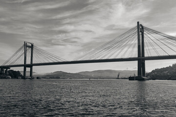 Obraz premium Bridge of Rande in Vigo, Spain, black and white image taken from a boat on the sea