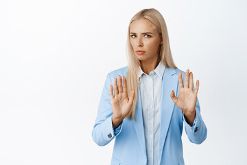 Reluctant corporate woman in blue suit making cross taboo gesture, refusing something, decline bad...