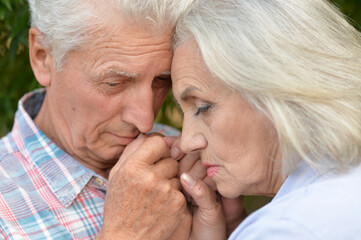 Portrait of unhappy senior couple in the park
