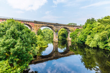 A view from the road brdige towards the railway viaduct at Yarm, Yorkshire, UK in summertime - obrazy, fototapety, plakaty
