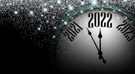 Obraz na płótnie Canvas Half hidden clock showing 2022 with stars confetti.