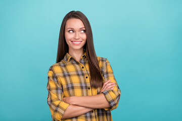 Photo of pretty cheerful girl folded hands beaming smile look empty space isolated on blue color background