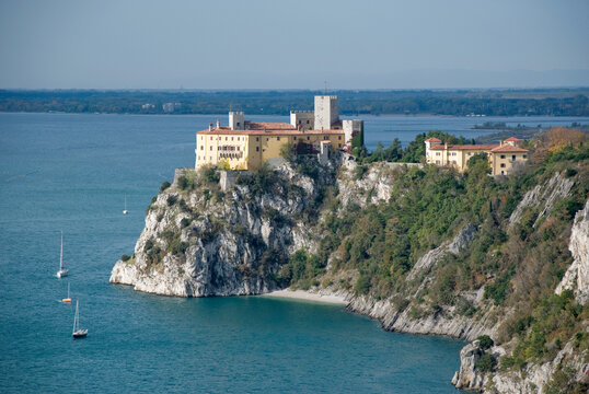 View to Duino castle standing on karst rocks in Italy