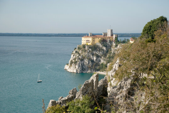 View to Duino castle standing on karst rocks in Italy