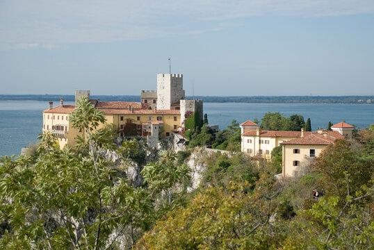 View to Duino castle standing on karst rocks in Italy
