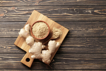Dry and ground ginger on a wooden background. Dry ginger in a bowl. Ginger in a spoon. Cooking...