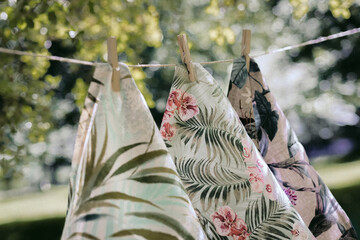 Three handkerchiefs decorated with a floral pattern hanging on the exterior