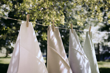 Handkerchiefs hung on clothespins in the open air