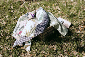 Several cloth handkerchiefs in a wooden basket