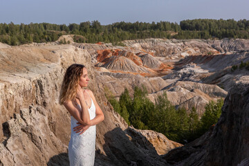 A beautiful woman on the background of landscape.Top view of the quarry