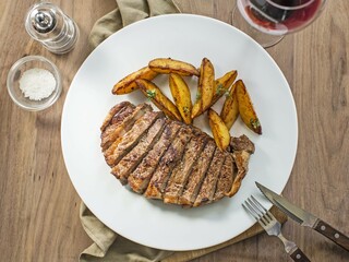 grilled steak with potatoes wedges