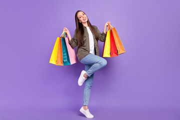 Full length body size photo woman keeping bags after shopping sale in shopping mall isolated pastel violet color background © deagreez