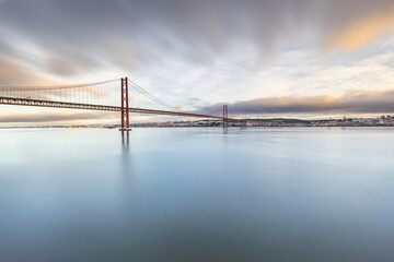 Fototapeta na wymiar the 25 de Abril suspension bridge over Tagus river in Lisbon, Portugal at sunrise