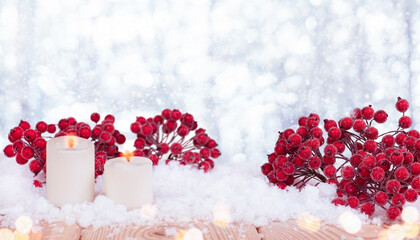 christmas background with candles and red  rowan in the snow