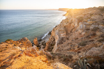 Stunning view over Praia do Camilo in Lagos, Algarve Portugal during the sunrise. Rocks, cliffs and formations in the ocean. Natural treasure. Portugal