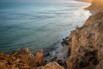 Stunning view over Praia do Camilo in Lagos, Algarve Portugal during the sunrise. Rocks, cliffs and formations in the ocean. Natural treasure. Portugal