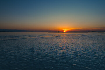Still waters of the Amur river at sunset in late September in Khabarovsk, Russia. 