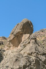 A huge boulder on top of a mountain range in the Caucasian mountains.