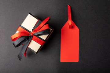 gift box with a price tag, on a black background. with copy space.
