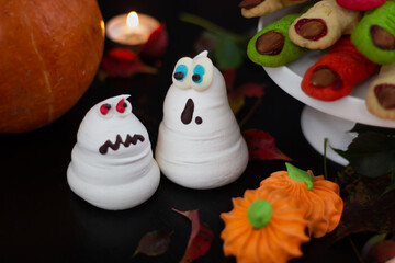 Halloween ensemble featuring delightful meringue phantoms, a classic pumpkin, and a collection of...