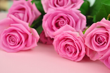 Bouquet of roses on pink background copy space 