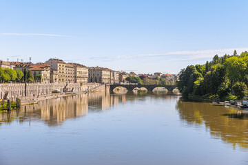 Fototapeta na wymiar Turin, Italy, May 12th, 2021. Generic view of the Po river with the Vittorio Emanuele I Bridge in the distance in the background.