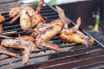 heavily fried chicken wings on the grill. High quality photo