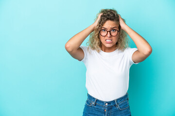 Girl with curly hair isolated on blue background doing nervous gesture