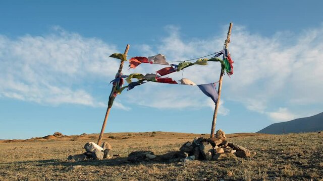 Religious tibetan buddhist prayer flags are flutter in the wind on blue sky background.